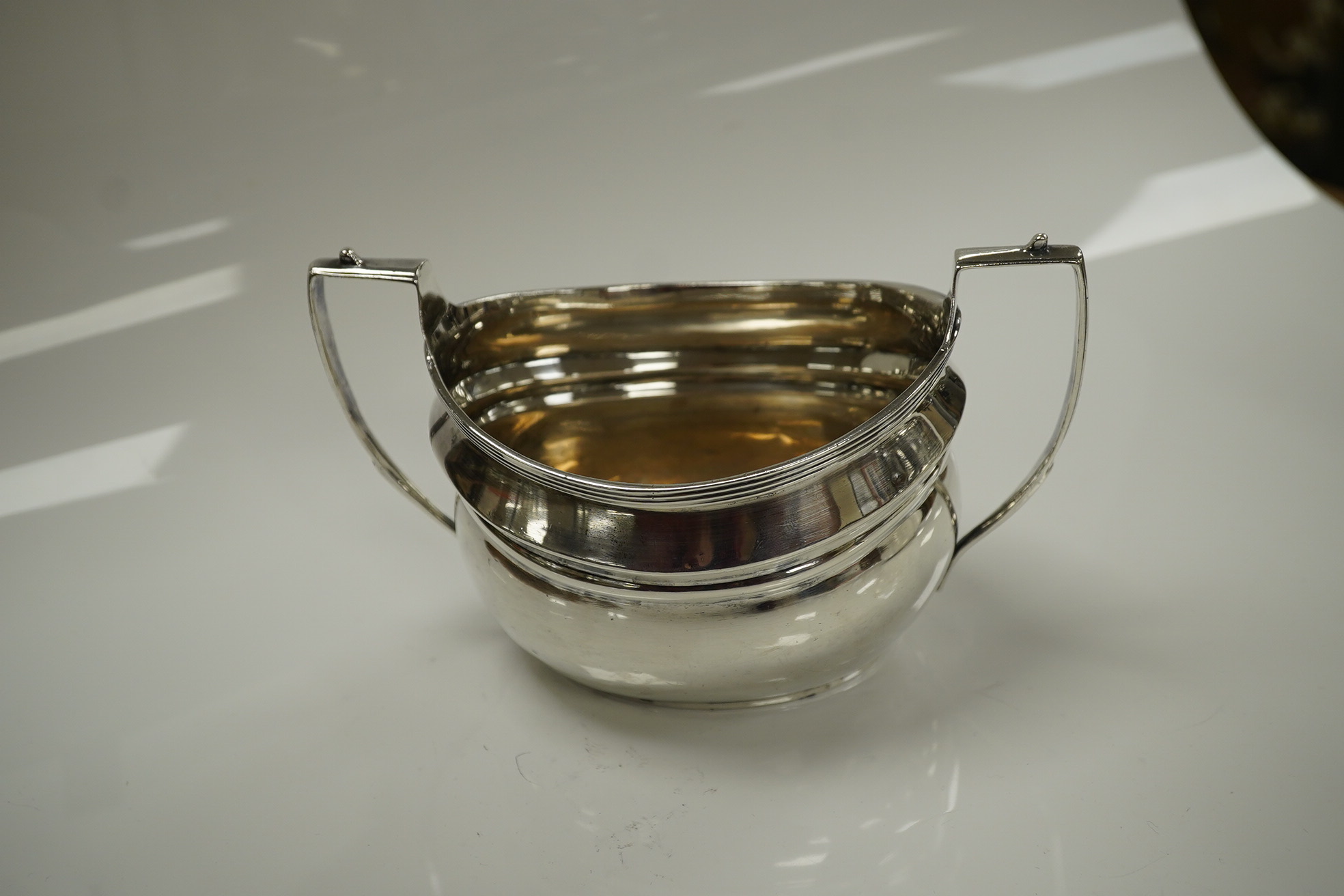 An Edwardian silver teapot and two handled sugar bowl by Charles Stuart Harris & Sons, London 1907, gross weight 23.4oz. Condition - poor to fair